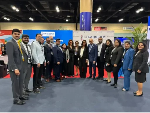 Somireddy Law Group team with founder Santosh Somireddy and Vijay Yellareddigari at a professional trade show booth.