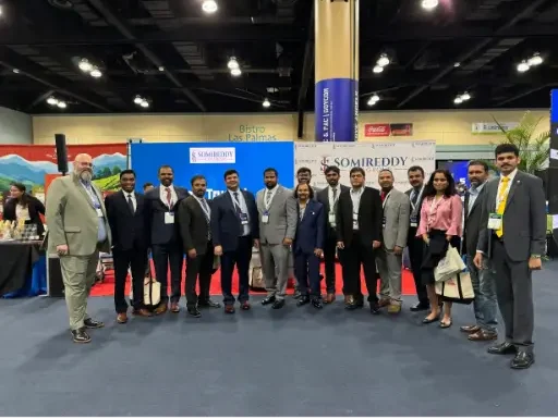 Somireddy Law Group attorneys Santosh Somireddy and Vijay Yellareddigari with the legal team at a trade show booth.