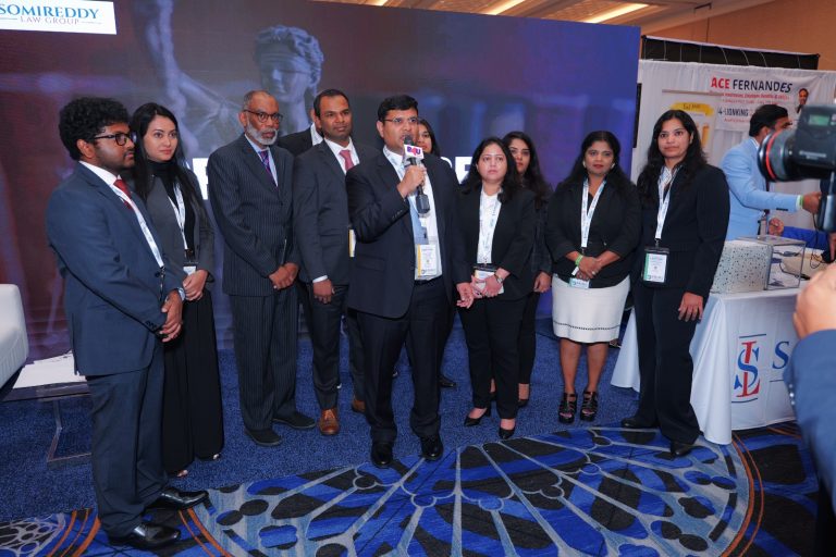 Somireddy Law Group's Santosh Somireddy speaking with Keith Blair, Vijay Yellareddigari, and their legal associates.