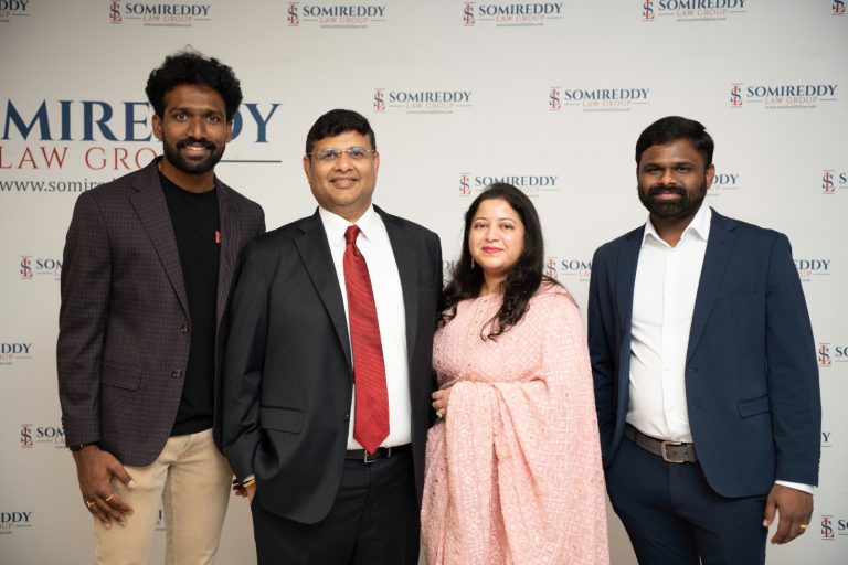 Group photo of the Somireddy Law Firm team, including attorneys Santosh R. Somireddy and Vijay Yellareddigari, outdoors.